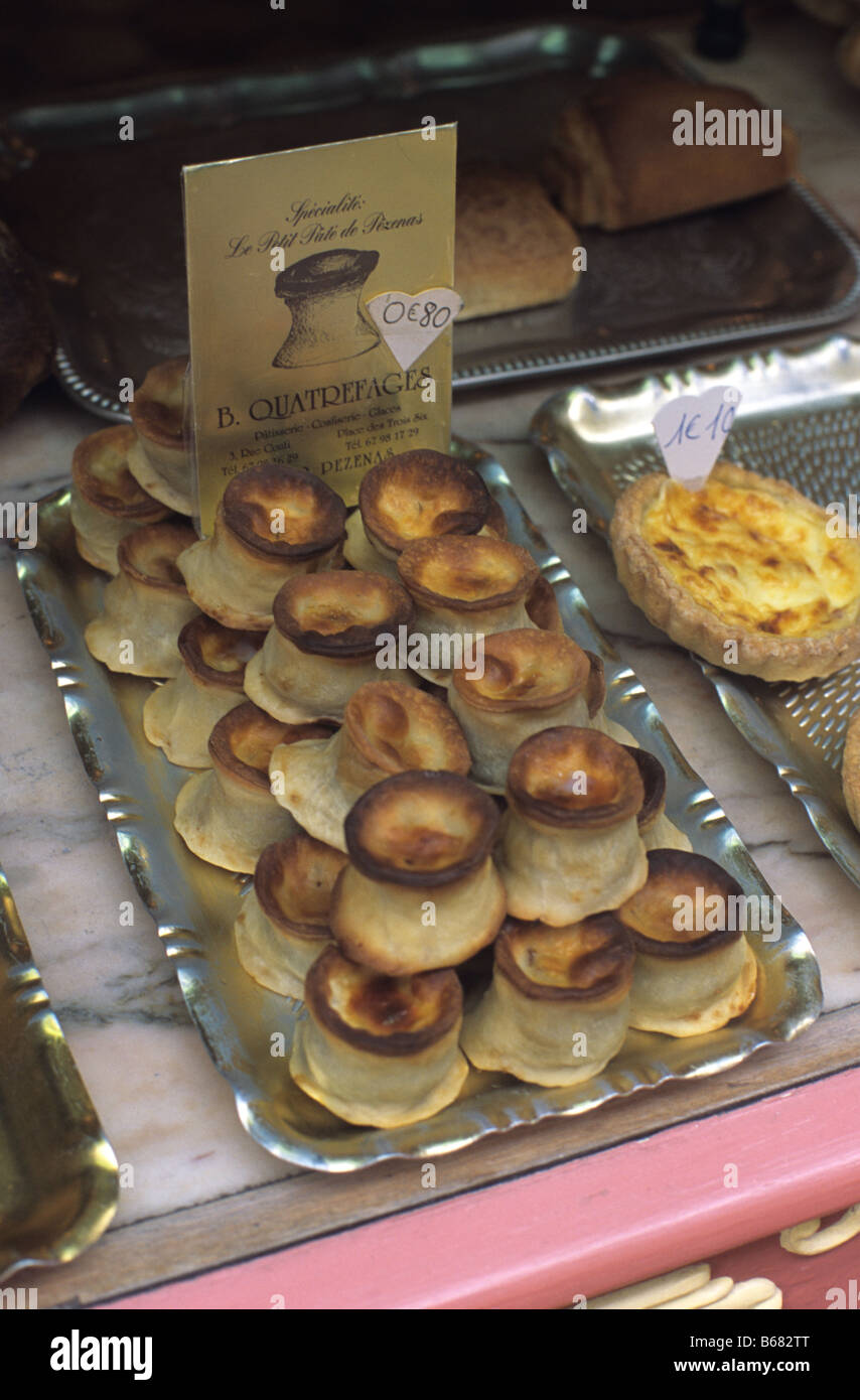 Petits Pâtés, a savoury meat pie or pastry, on display in the window of a patisserie, Pézenas, Herault département, France Stock Photo