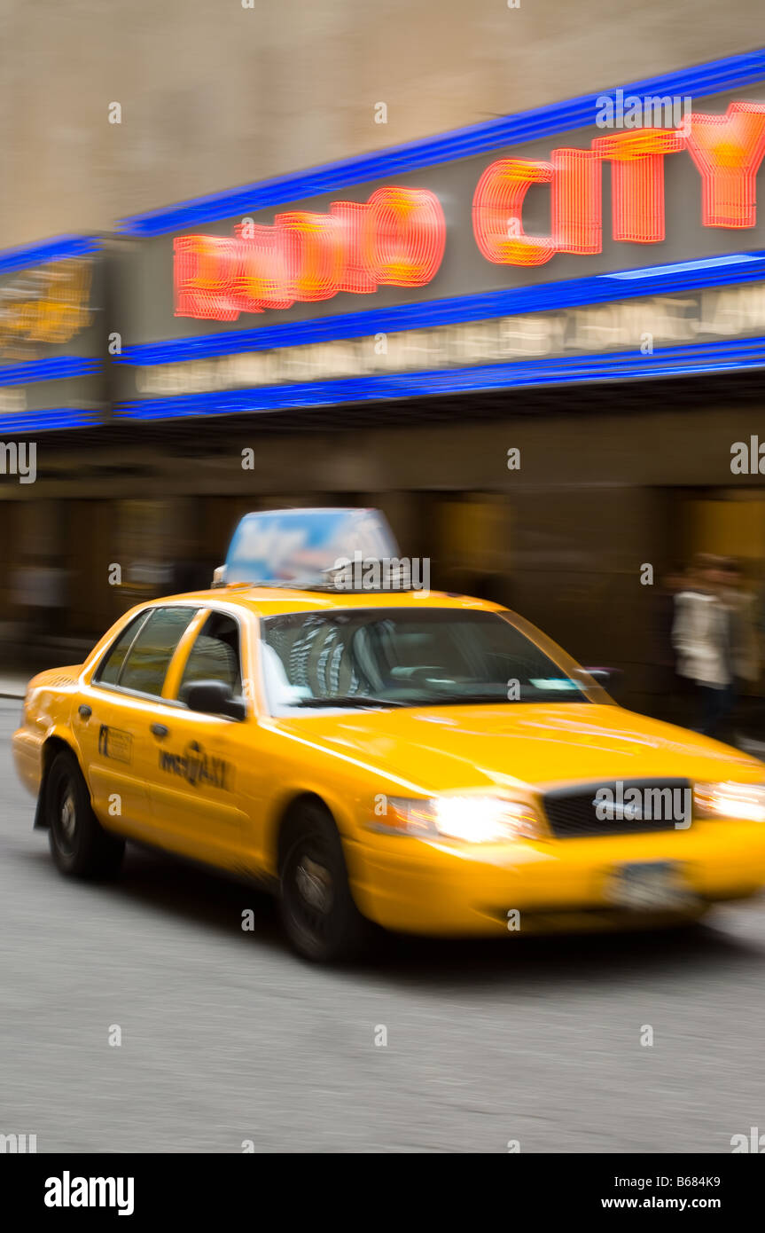 a taxi cab streaks past Radio City Music Hall Stock Photo