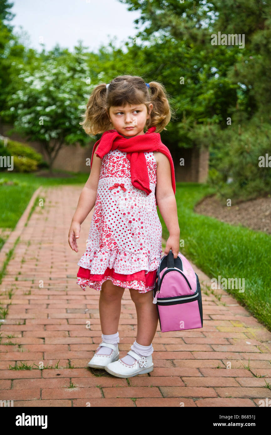 Little Girl Carrying Lunch Bag Stock Photo