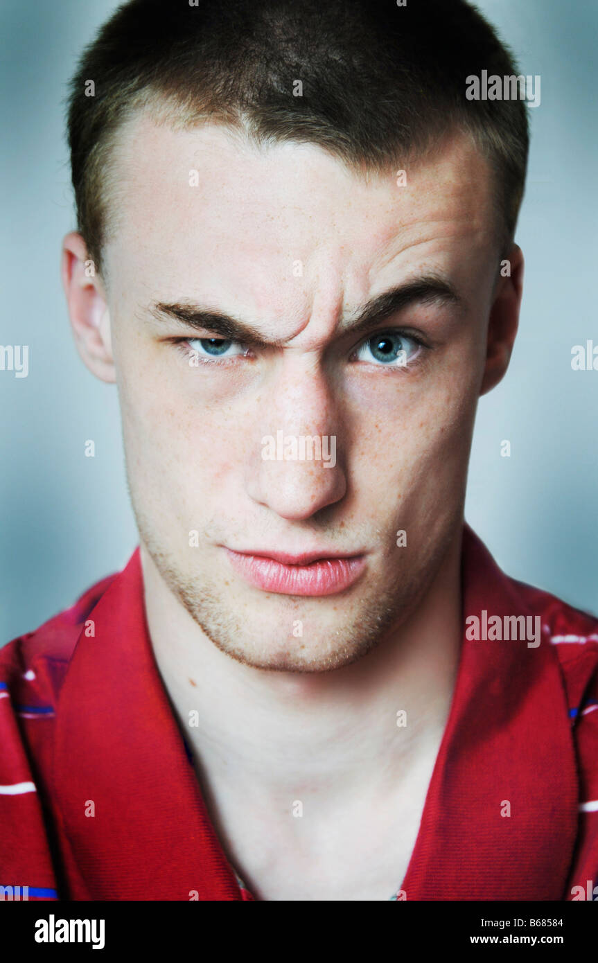 Portrait of Young Man with Raised Eyebrow Stock Photo