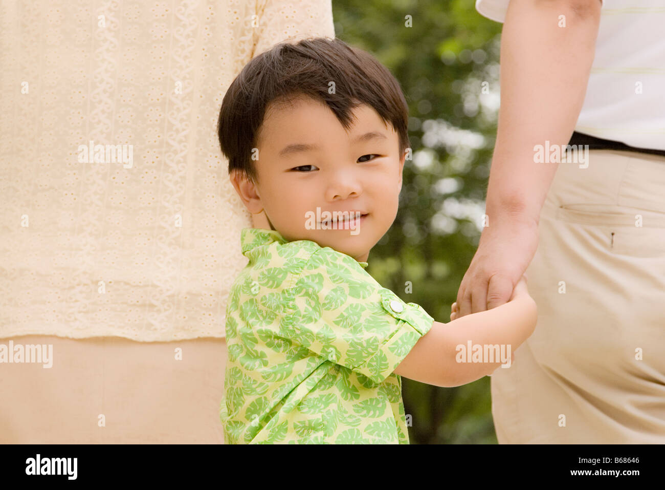 Portrait of a boy walking with his grandparents Stock Photo