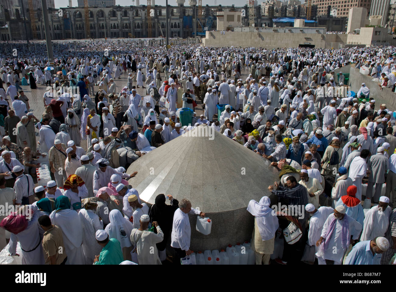 Muslim pilgrims lining up to fill Zam Zam water in their plastic