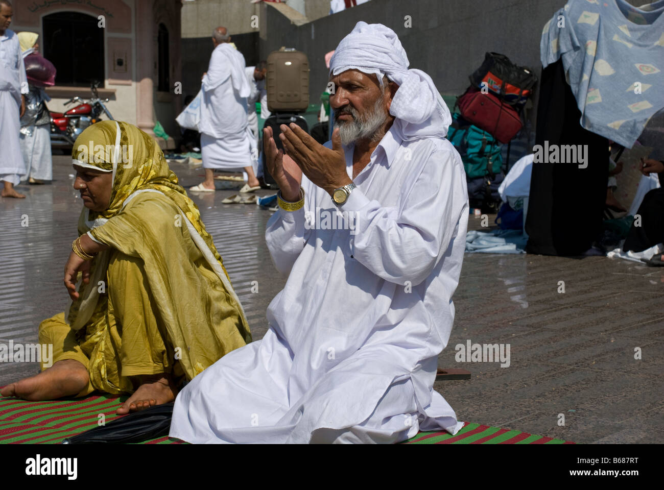 An elderly muslim couple sitting on their prayer rugs Makkah Saudi