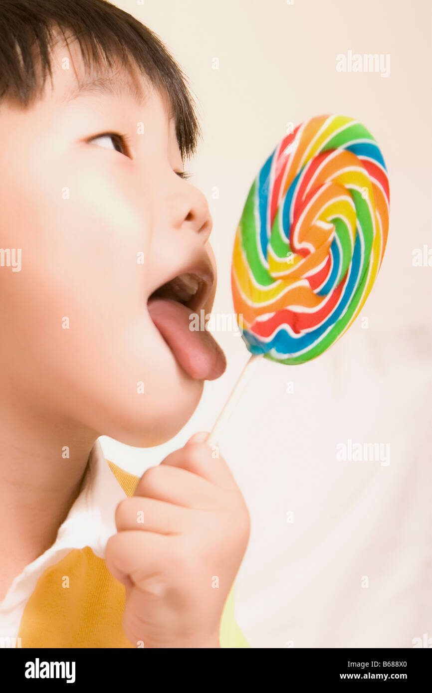 Closeup of a boy licking a lollipop Stock Photo Alamy