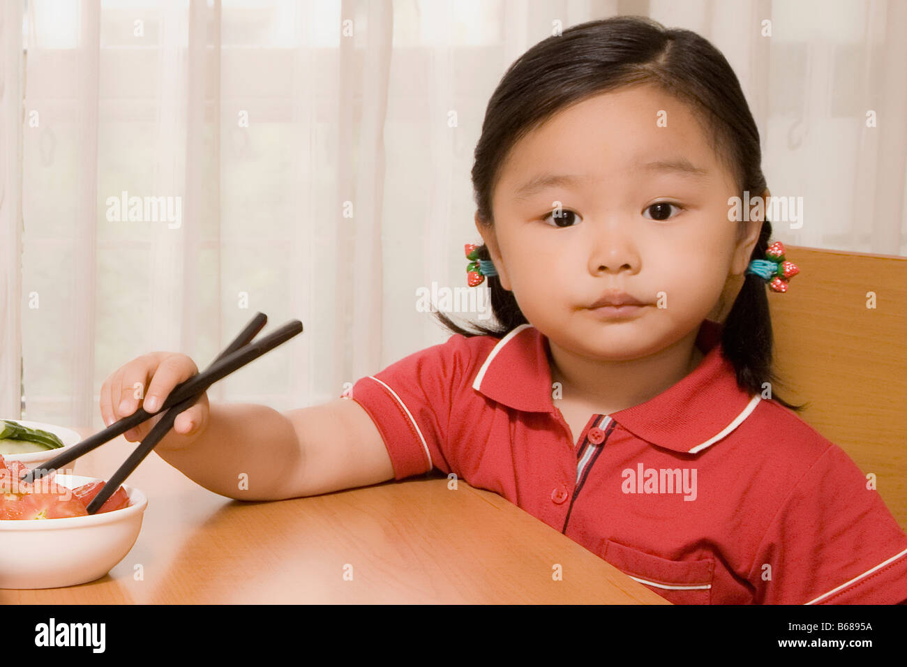 Portrait of a girl eating salad with chopsticks Stock Photo Alamy