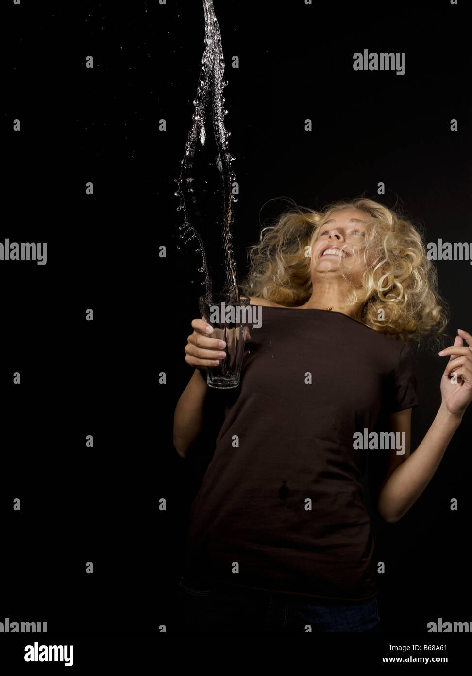 Woman throwing water from a glass Stock Photo Alamy