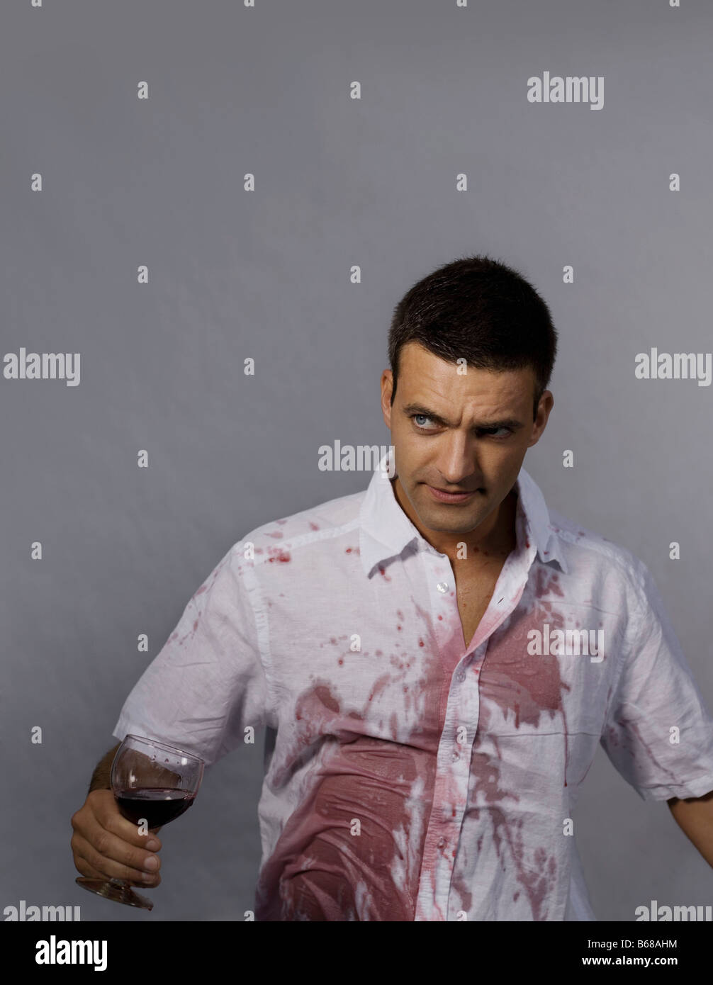 Man with red wine on his shirt Stock Photo - Alamy