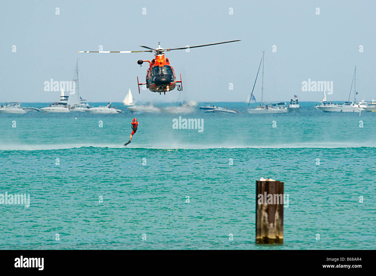 U.S. Coast Guard Helicopter & Boat Rescue / Lifting rescue swimmer out of water Stock Photo