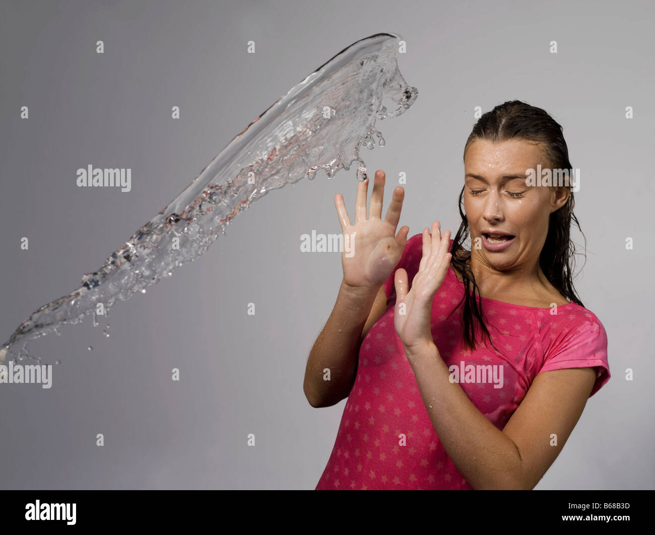 Woman splashed with water Stock Photo Alamy