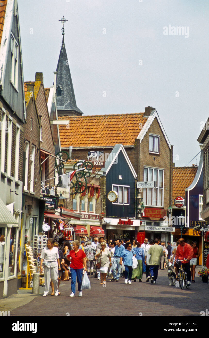 Tourists walk through Volendam, The Netherlands. Stock Photo