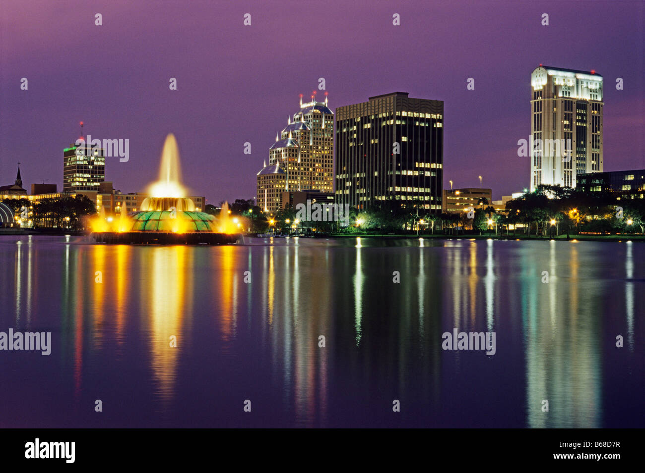 Orlando, Florida, downtown skyline reflects in Lake Eola after sunset