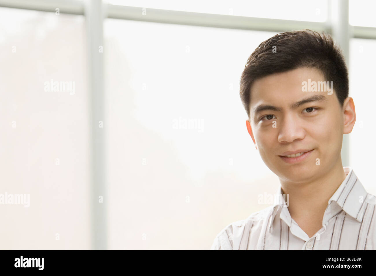 Portrait of a male office worker smiling Stock Photo - Alamy