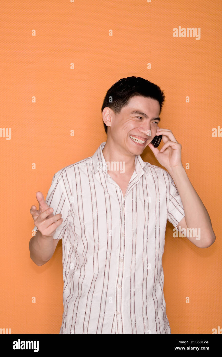 Male office worker talking on a mobile phone and smiling Stock Photo
