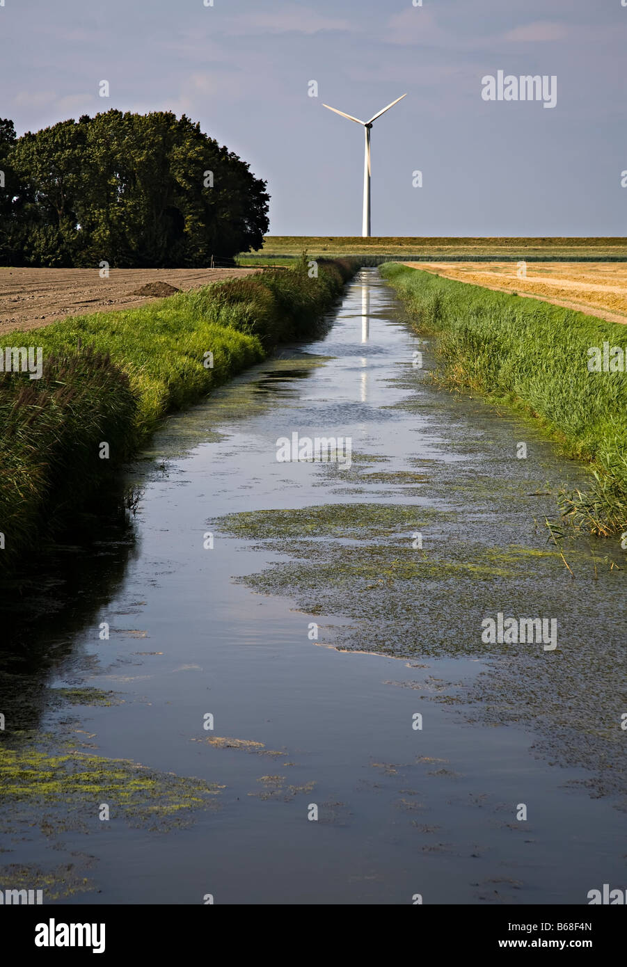 Wind turbine and irrigation canal Netherlands Stock Photo