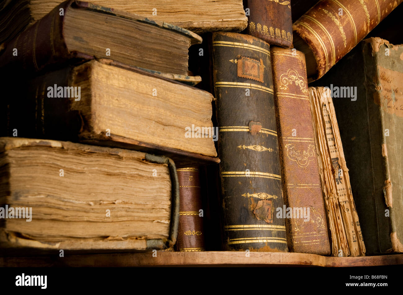 Very old and dusty books spine in a heap on a bookshelf Stock Photo Alamy