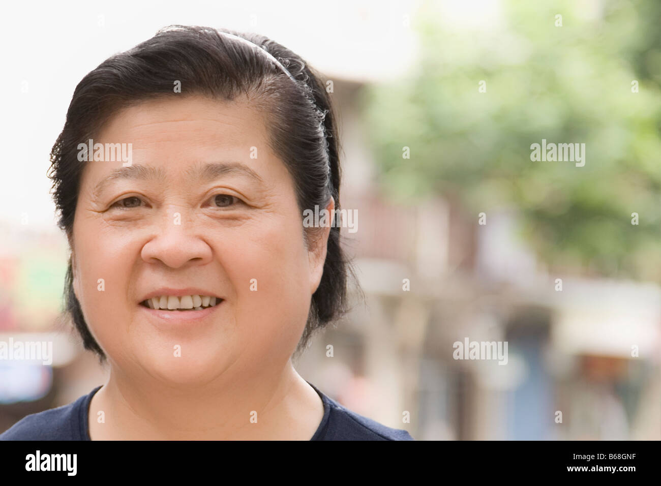 Portrait of a senior woman smiling Stock Photo - Alamy