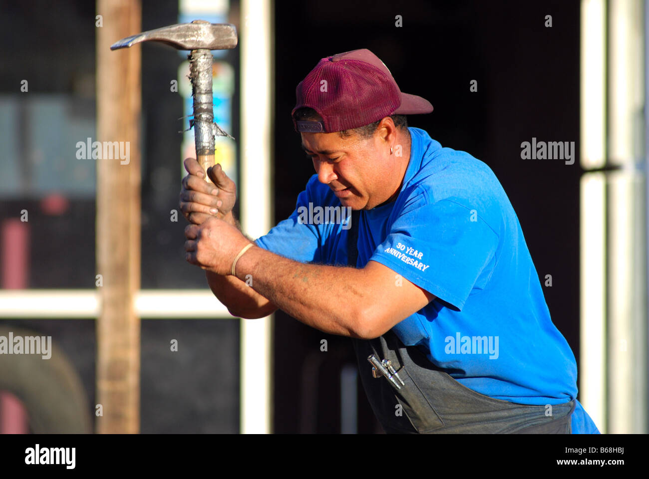 Hard working man swinging a pick Stock Photo