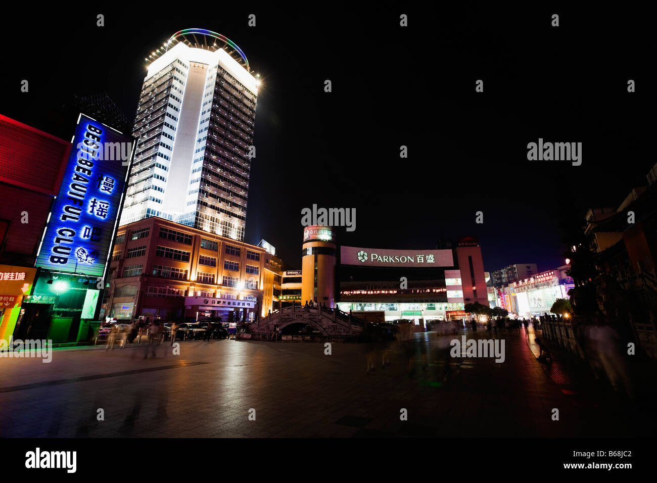 Low angle view of buildings lit up at night, Hefei, Anhui, China Stock Photo