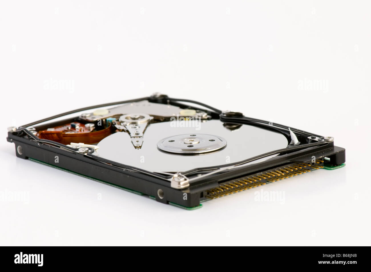 Opened hard disk showing the disk surface and drive head Stock Photo