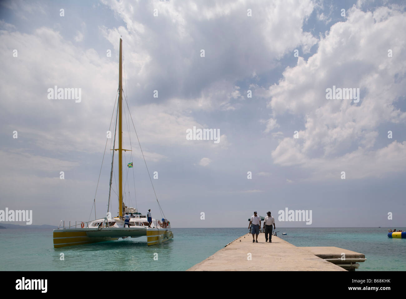 Jamaica Montego Bay Tourist catamaran along boat pier at Doctor s Cave Stock Photo