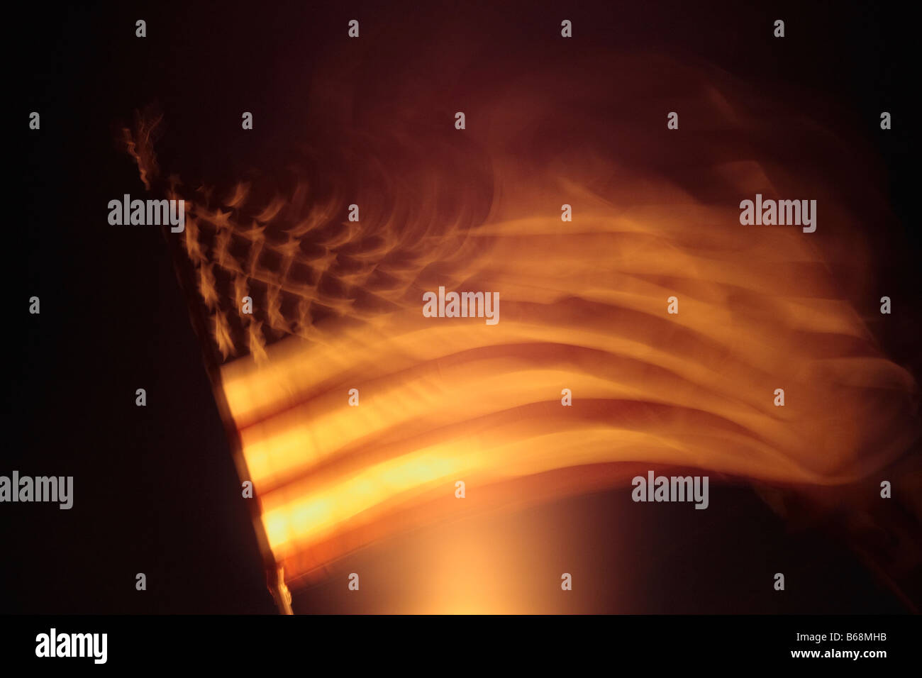 American Flag at night blowing and blurred Stock Photo Alamy