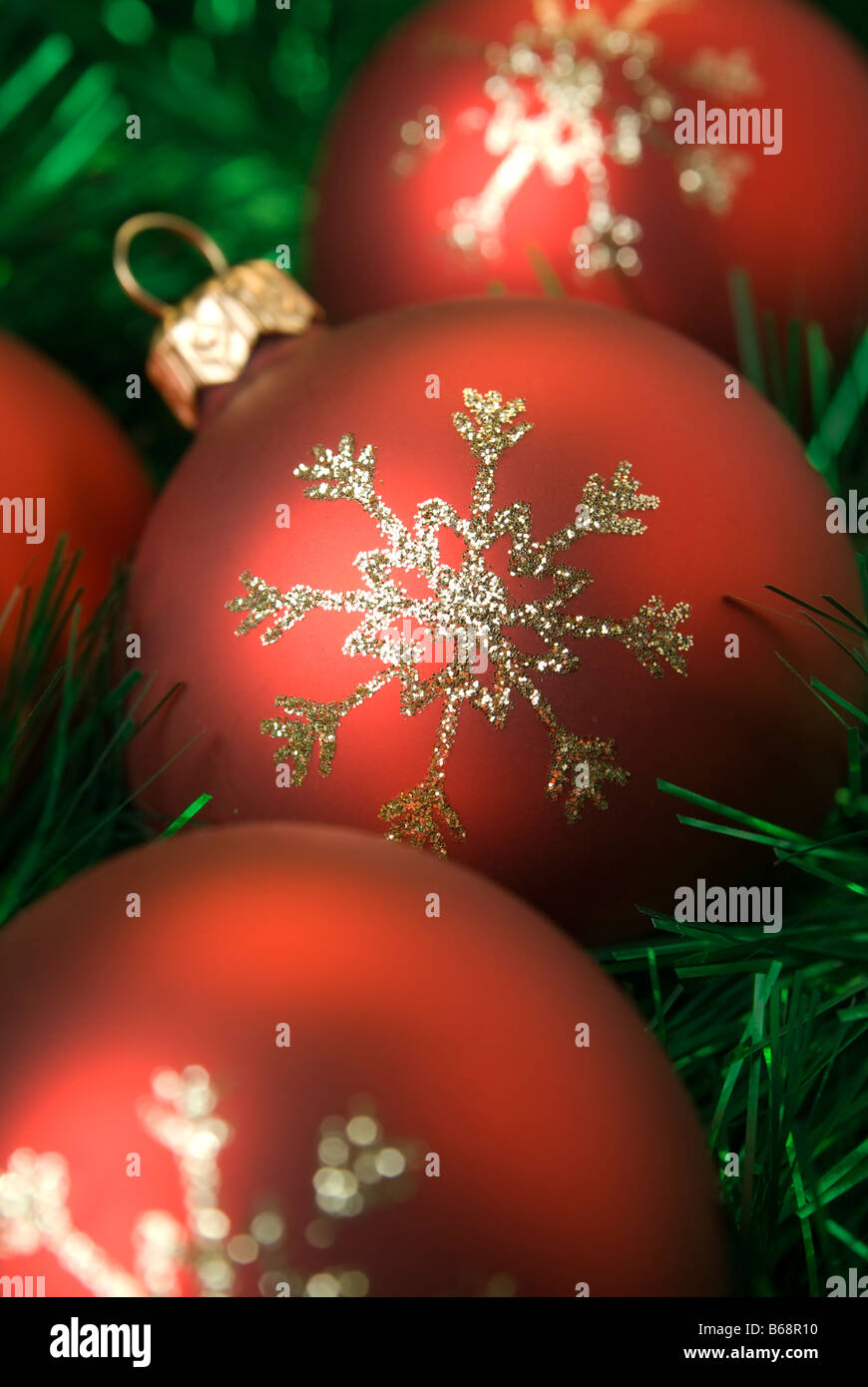 Red christmas balls on the green tinsel. Shallow dof, aRGB. Stock Photo