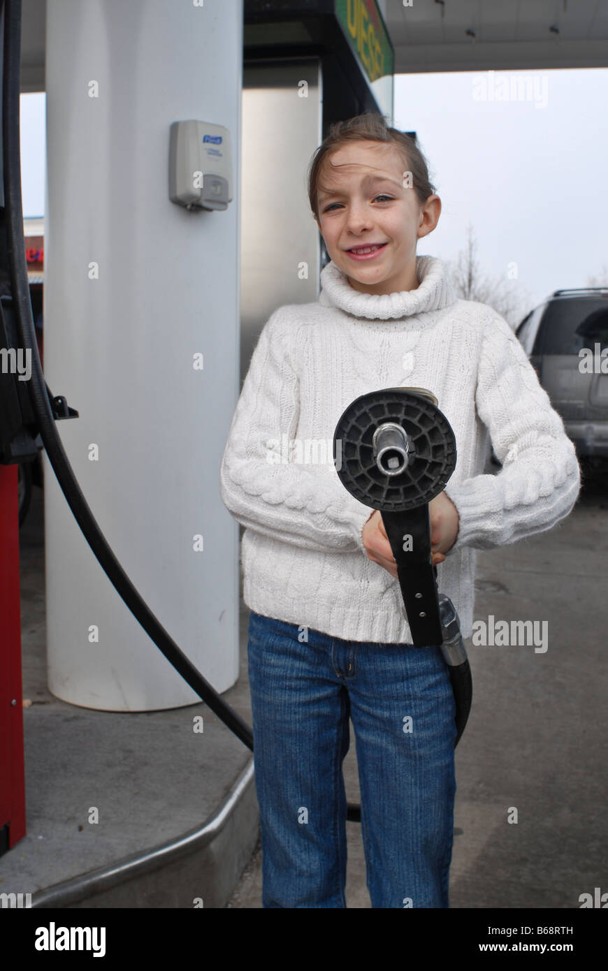 Kid pumping gas Stock Photo Alamy