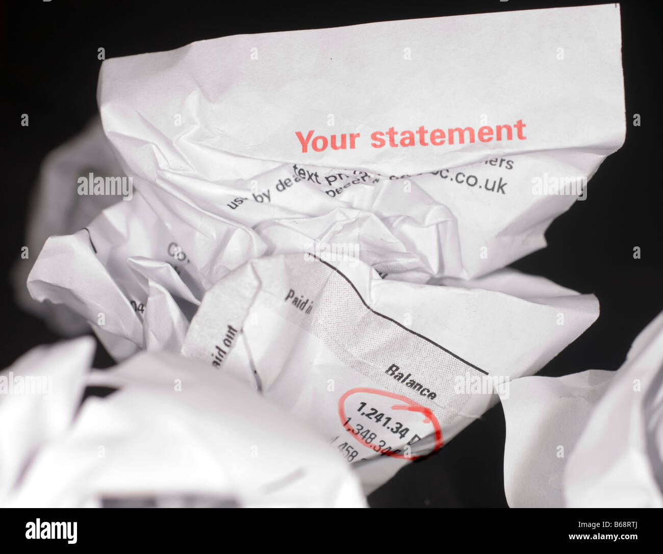 A crumpled bank statement shows how people can sometimes deny their own financial problems and mounting debts Stock Photo
