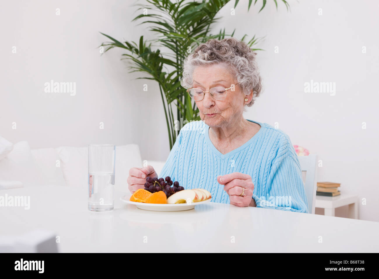 Senior woman eating fruits Stock Photo