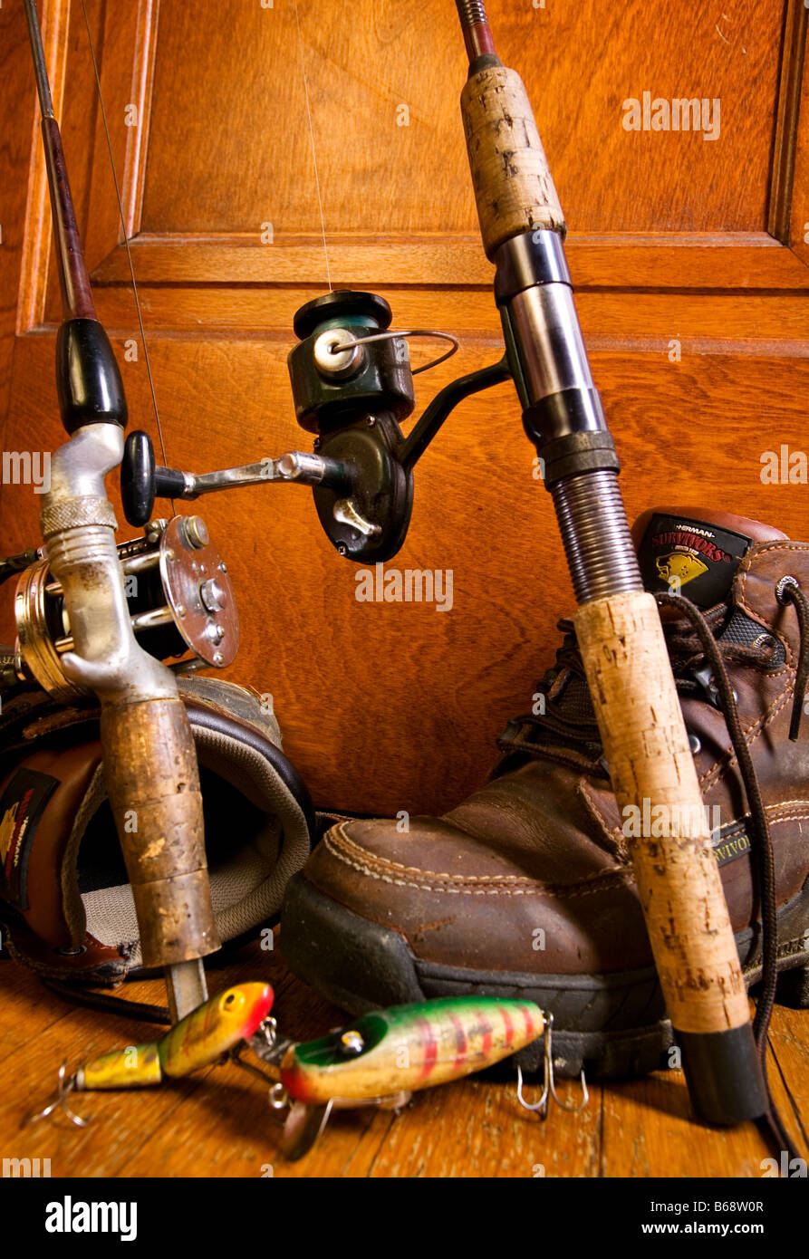 Old fishing tackle rods and reels in a corner with hiking boots Stock Photo  - Alamy