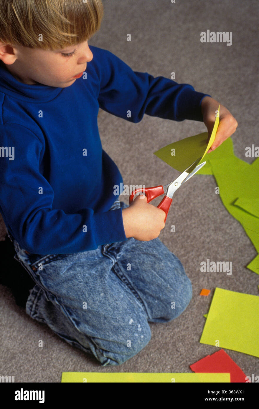 Young boy cutting paper Stock Photo Alamy