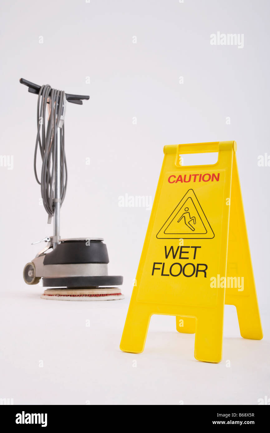 Hard floor cleaner with warning sign Stock Photo