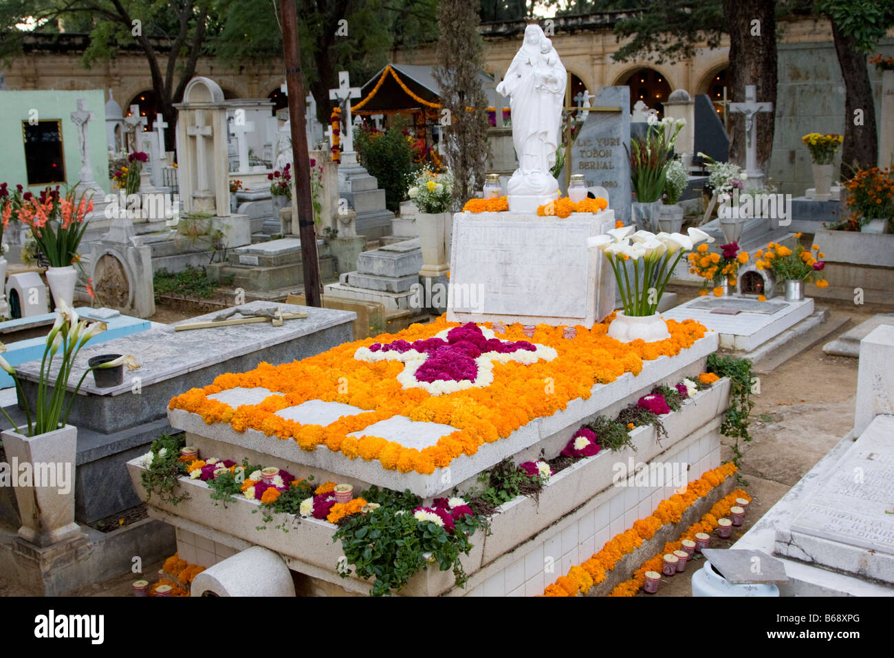 Oaxaca, Mexico. Day of the Dead.  Marigolds and Cockscomb Decorate a Grave in Memory of the Dead, San Miguel Cemetery. Stock Photo
