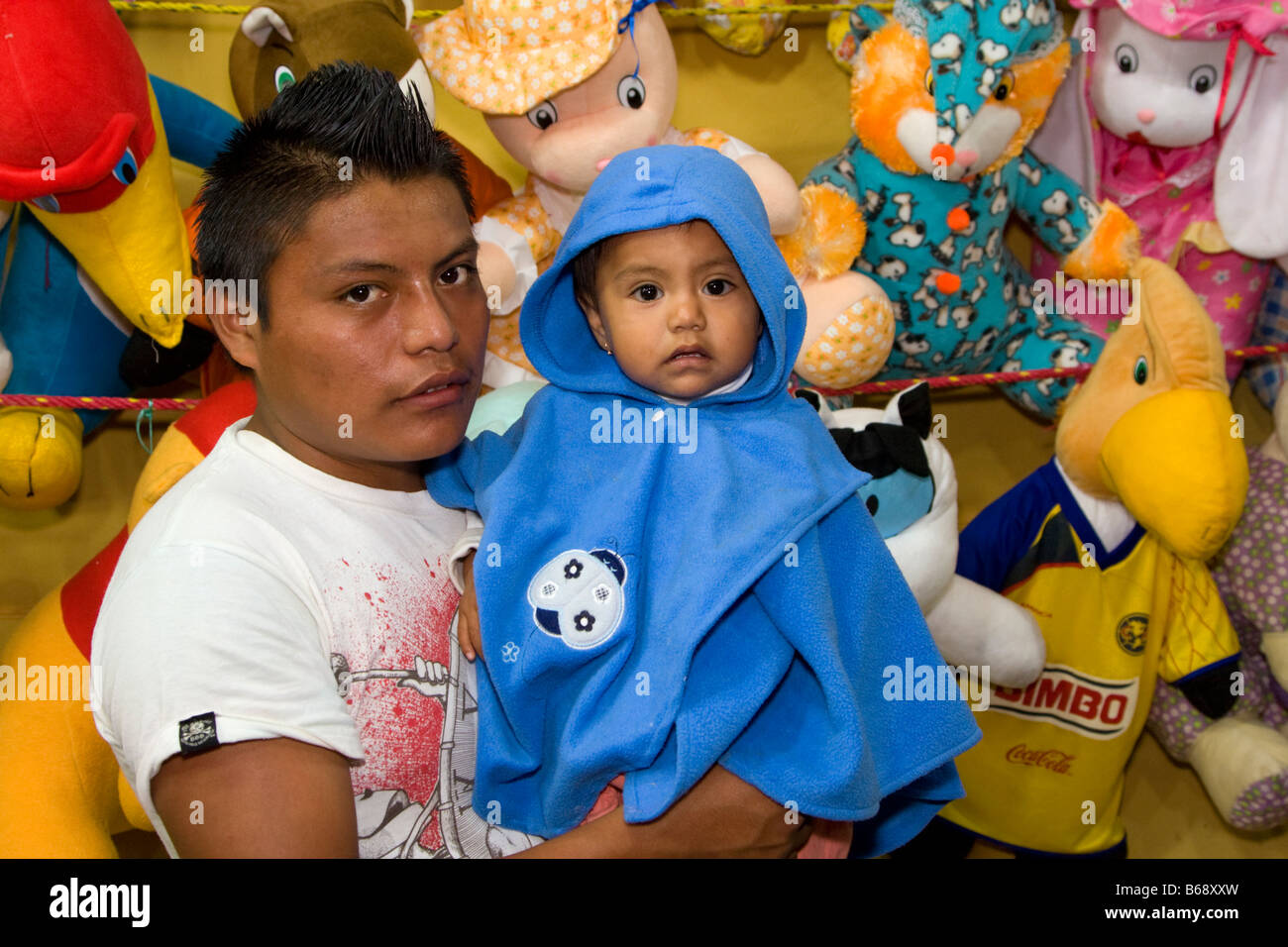 Oaxaca, Mexico. Day of the Dead.  Mother and Daughter at Stuffed Animal Stand outside entrance to San Miguel Cemetery. Stock Photo
