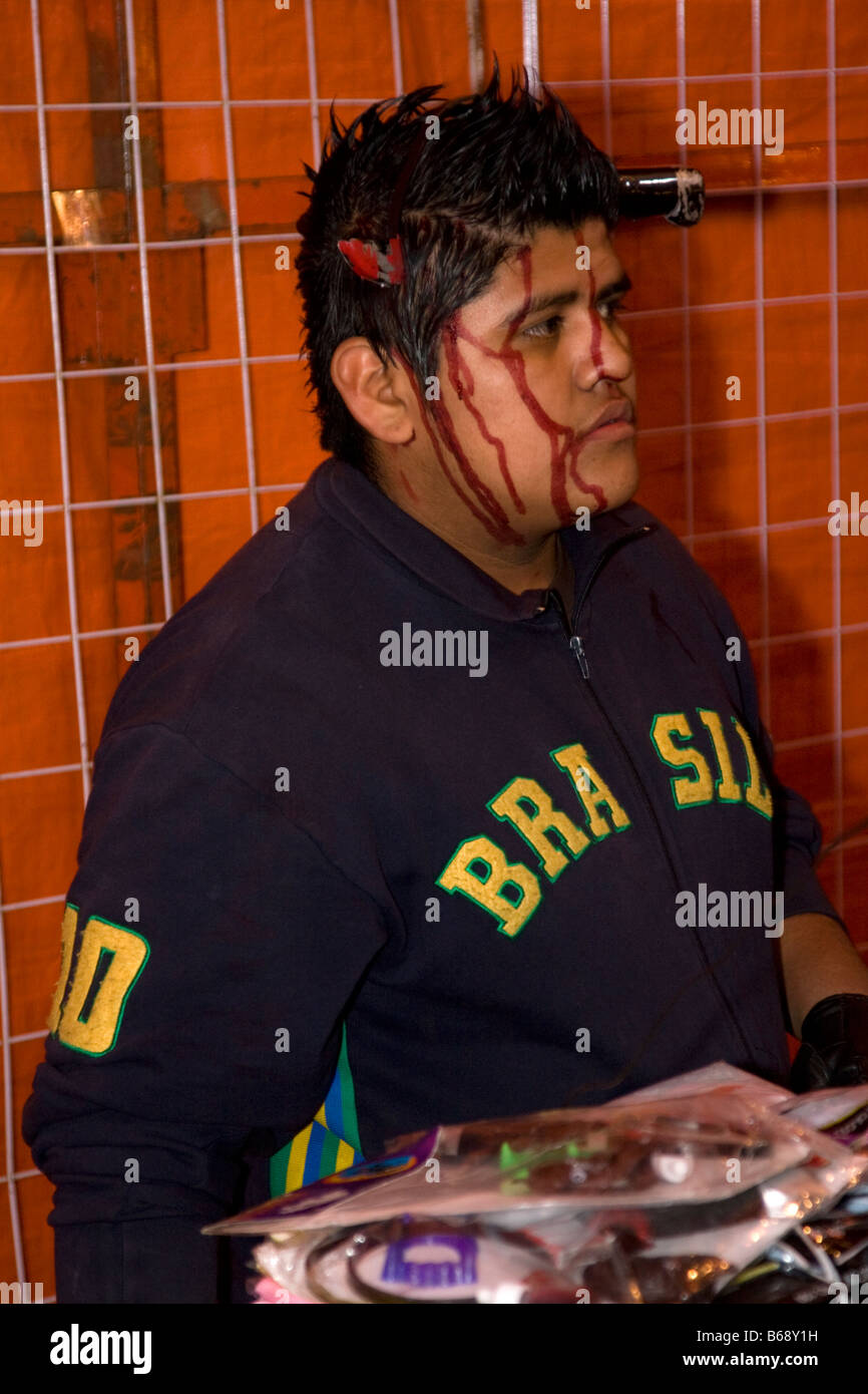 Oaxaca, Mexico. Day of the Dead.   An Amusement Stand Attendant disguises himself in a ghoulish costume, San Miguel Cemetery. Stock Photo