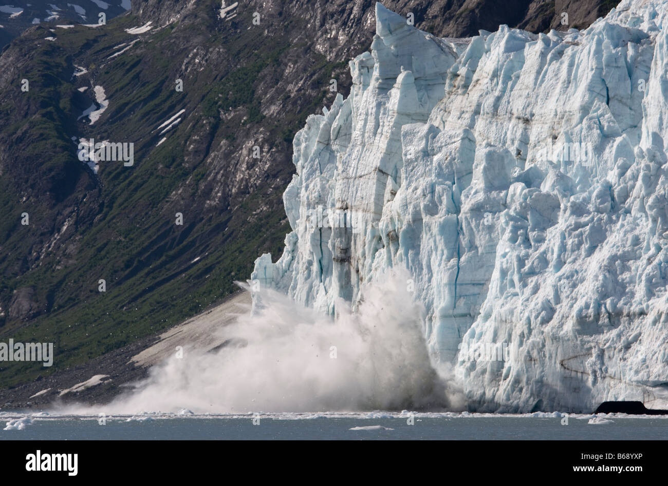 USA Alaska Glacier Bay National Park Icebergs calve with explosive splash from Margerie Glacier in Tarr Inlet on summer morning Stock Photo
