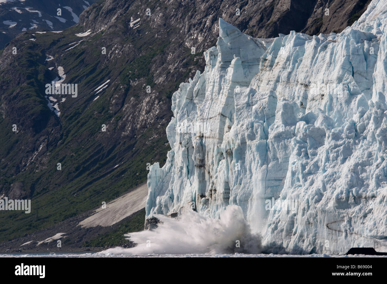 USA Alaska Glacier Bay National Park Icebergs calve with explosive splash from Margerie Glacier in Tarr Inlet on summer morning Stock Photo