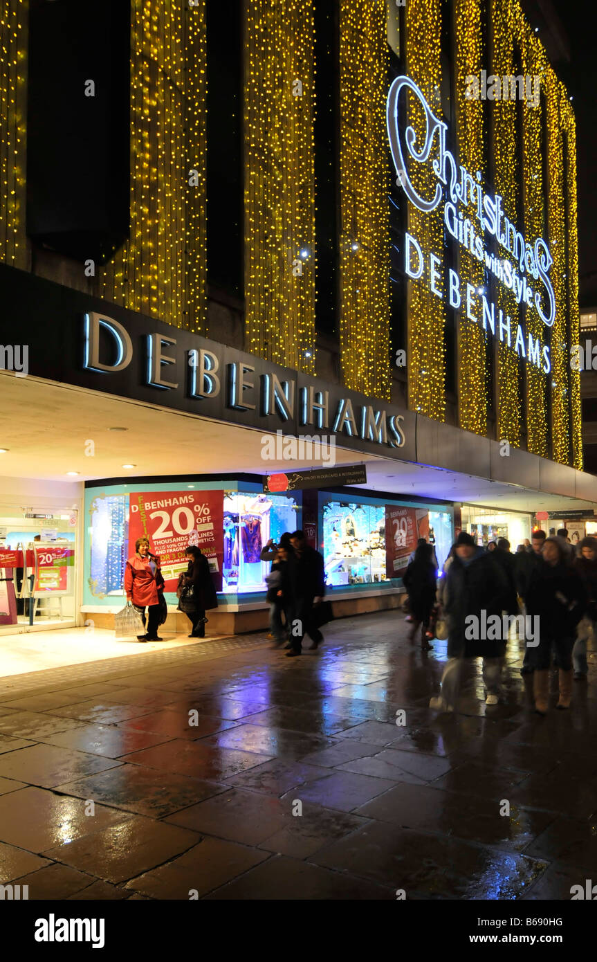 Debenhams department store Oxford street with Christmas lights in Londons West End rainy evening Stock Photo