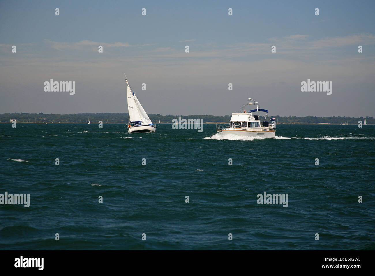Motor boat and yacht in the Solent outside Yarmouth harbour Isle of Wight England UK Stock Photo