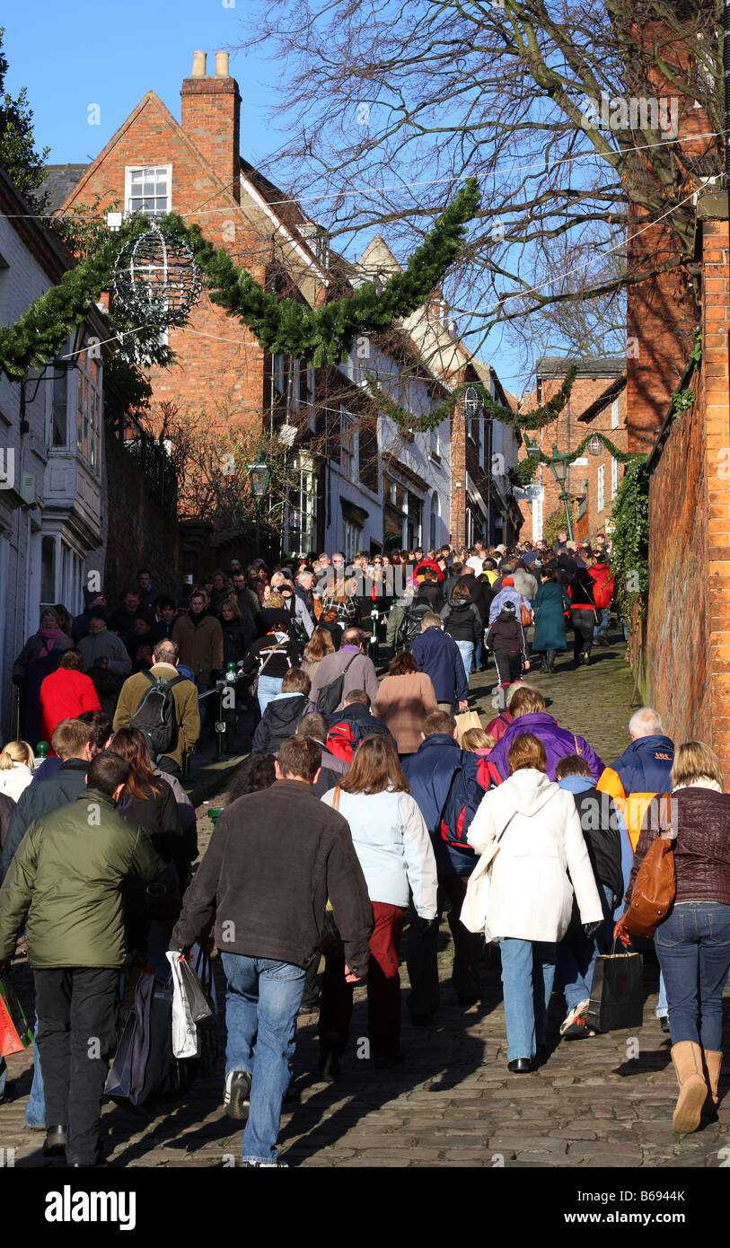 Crowds walking to Lincoln Christmas Market, Steep Hill, Lincoln, England, U.K. Stock Photo