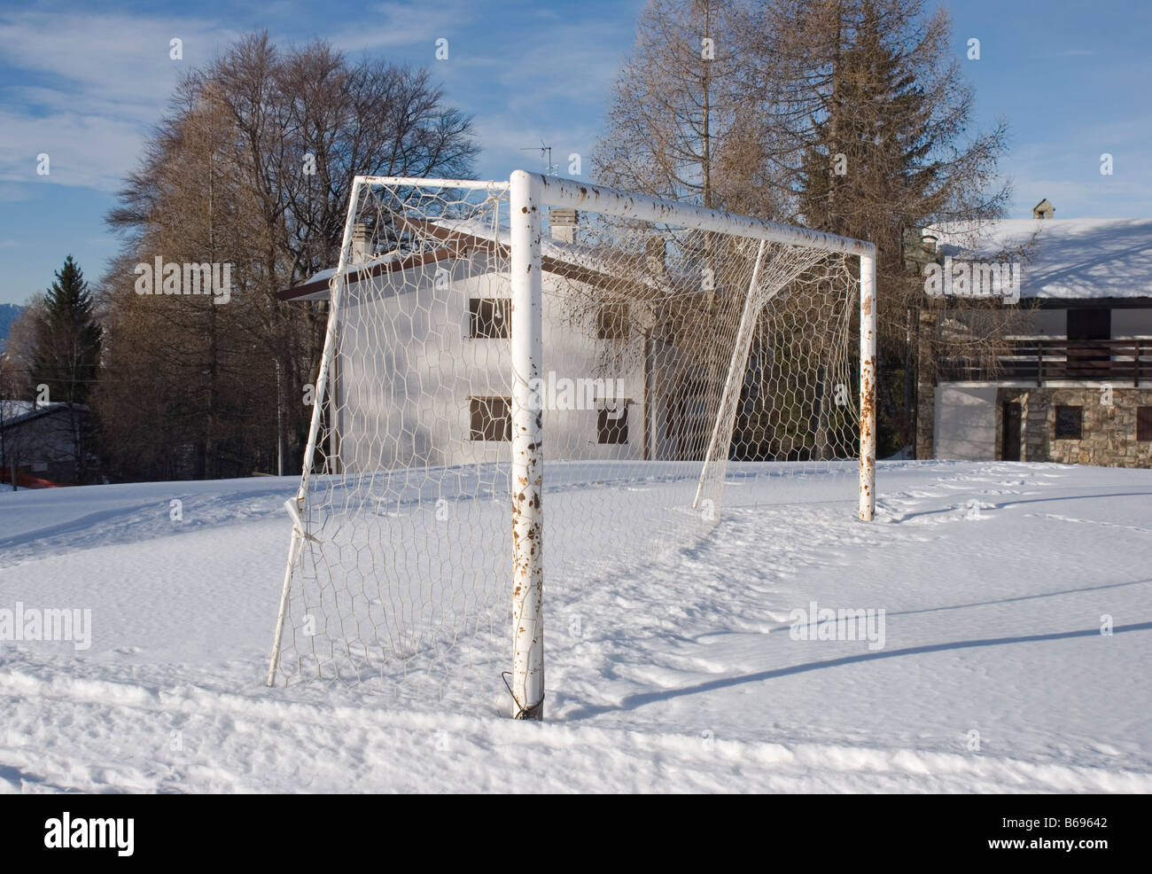 mountain village with football field during the winter Stock Photo