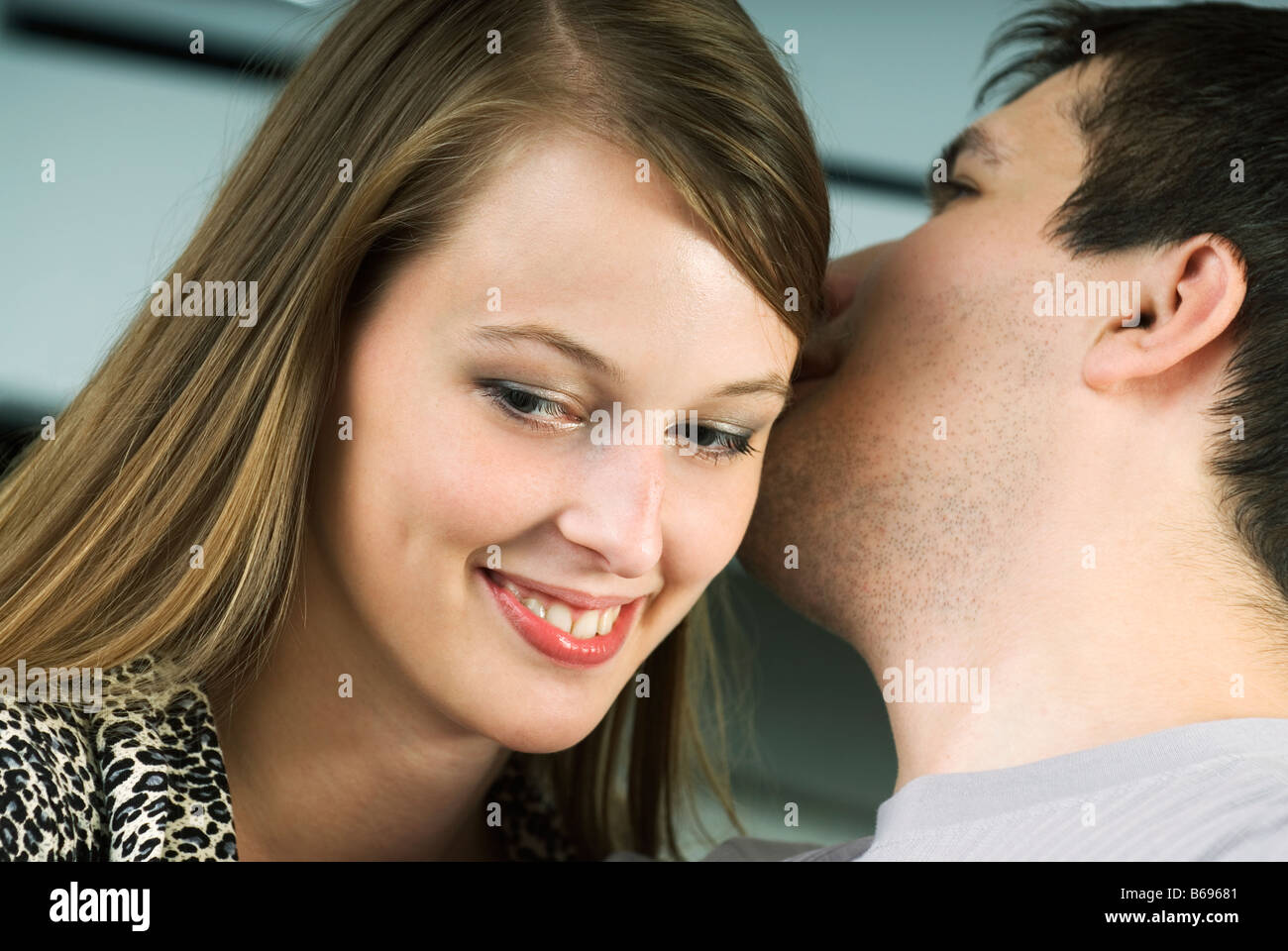 Man whispering in womans ear hires
