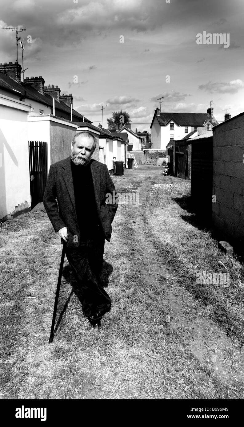 Irish novelist and playwright Patrick McCabe leaning on a walking stick Stock Photo