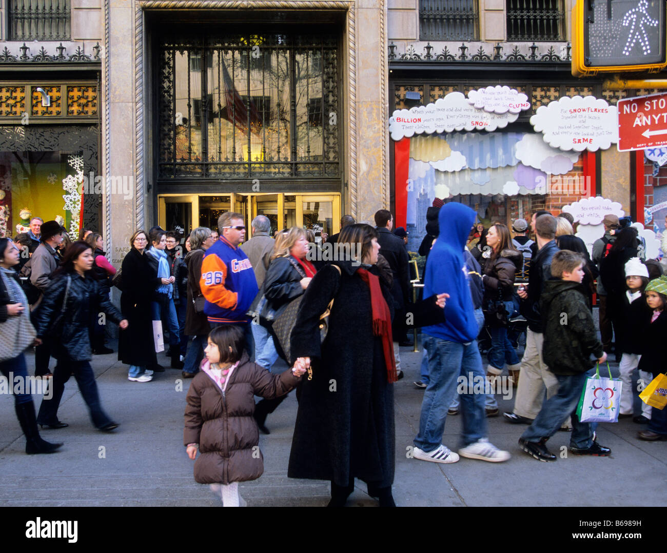 New York City Christmas shoppers and tourists on a crowded Fifth Avenue street in Midtown Manhattan in  front of Sak's Fifth Avenue. USA Stock Photo