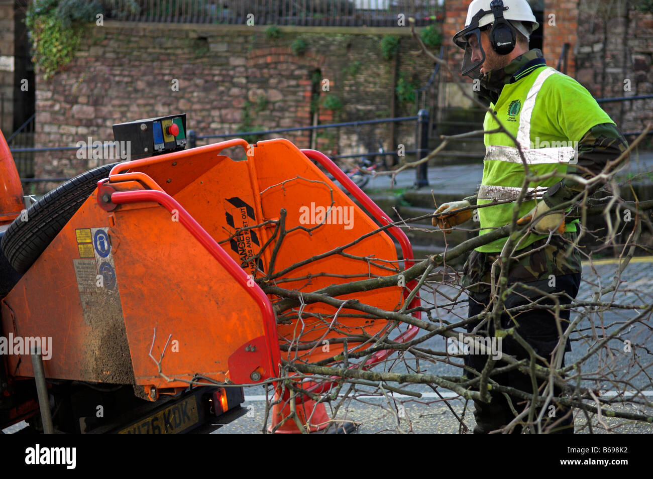 Man on street wood chipper hires stock photography and images Alamy