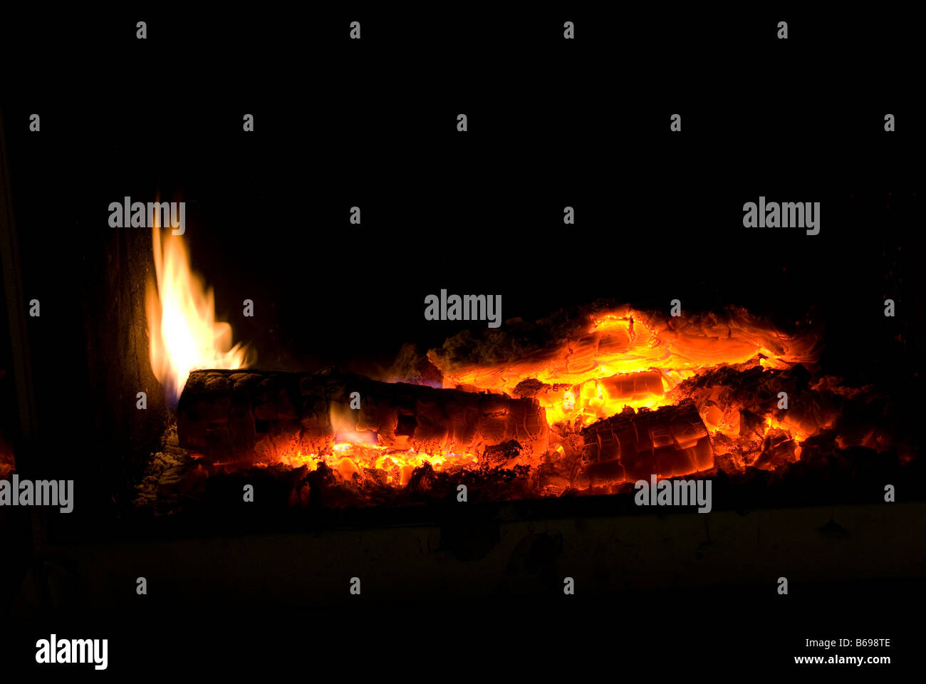 Red glowing embers in an ingle hearth Stock Photo