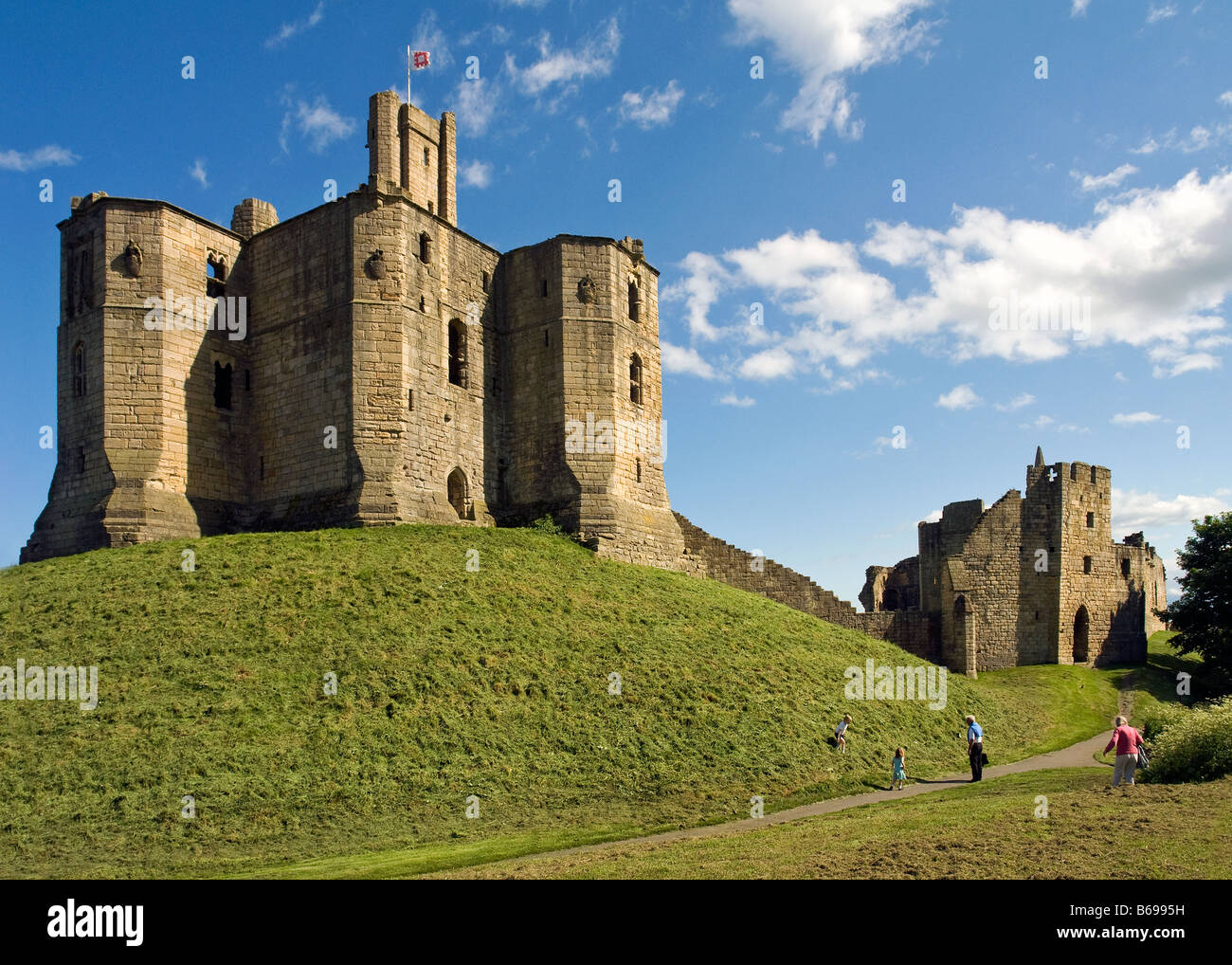 Warkworth Castle Keep with family in grounds, Warkworth, Northumbria Stock Photo