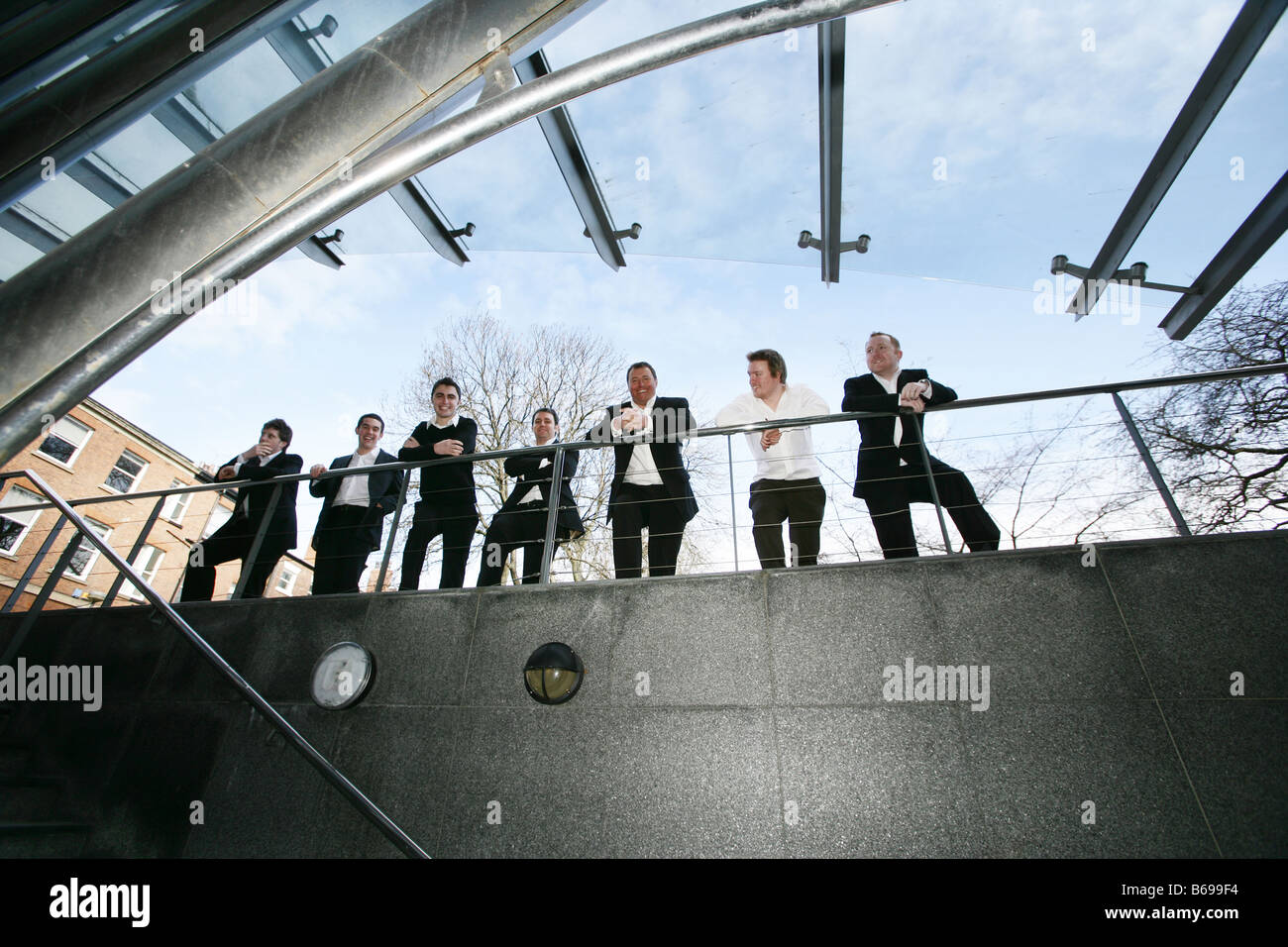 Seven 7 businessmen stood in a line facing the camera Stock Photo - Alamy