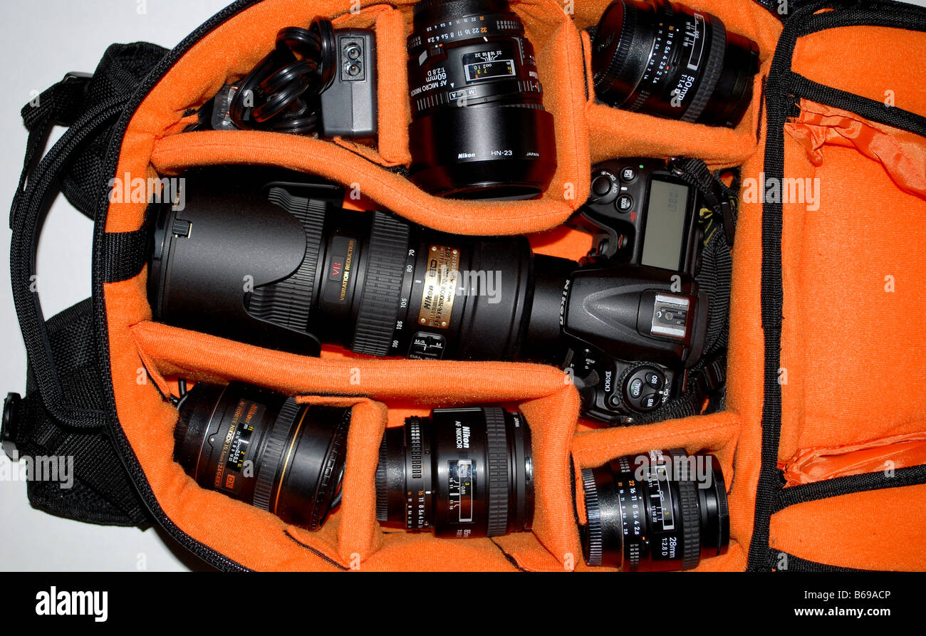 A camera bag, perfectly organized, filled with Nikon photography equipment, telephoto lenses, flash, cables, camera body. Stock Photo