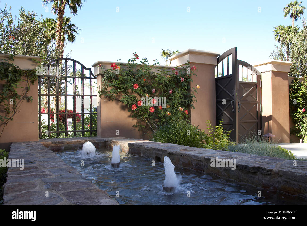 Courtyard entry fountain with gates Stock Photo Alamy